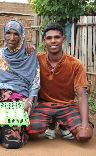 Joyful Ethiopian woman standing beside her children after receiving essential aid from Islamic Relief Ethiopia.